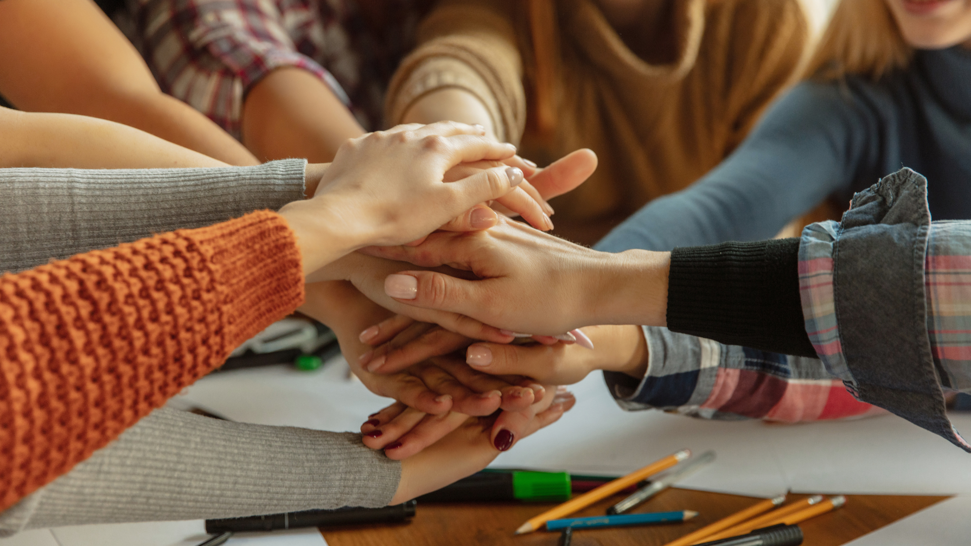 Women putting theirs hands together