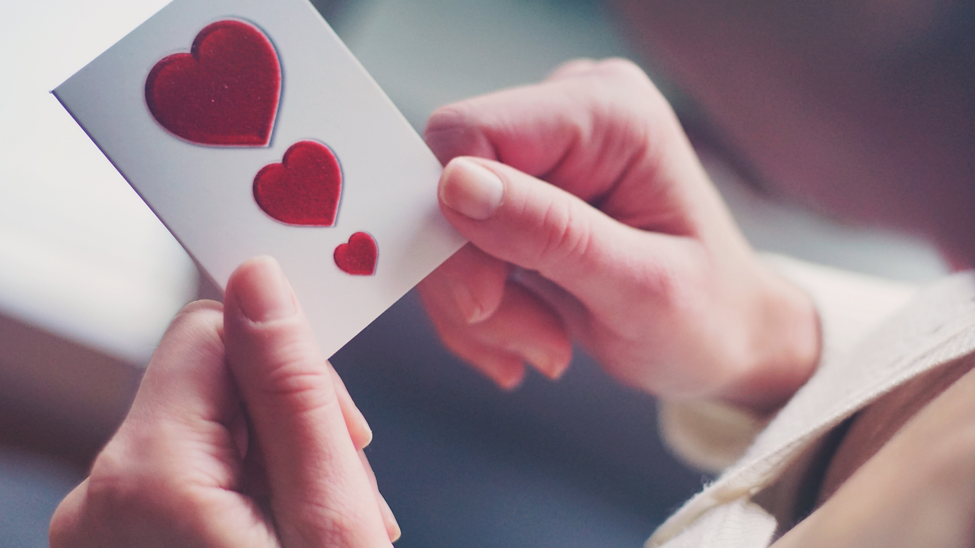 Person holding card with hearts